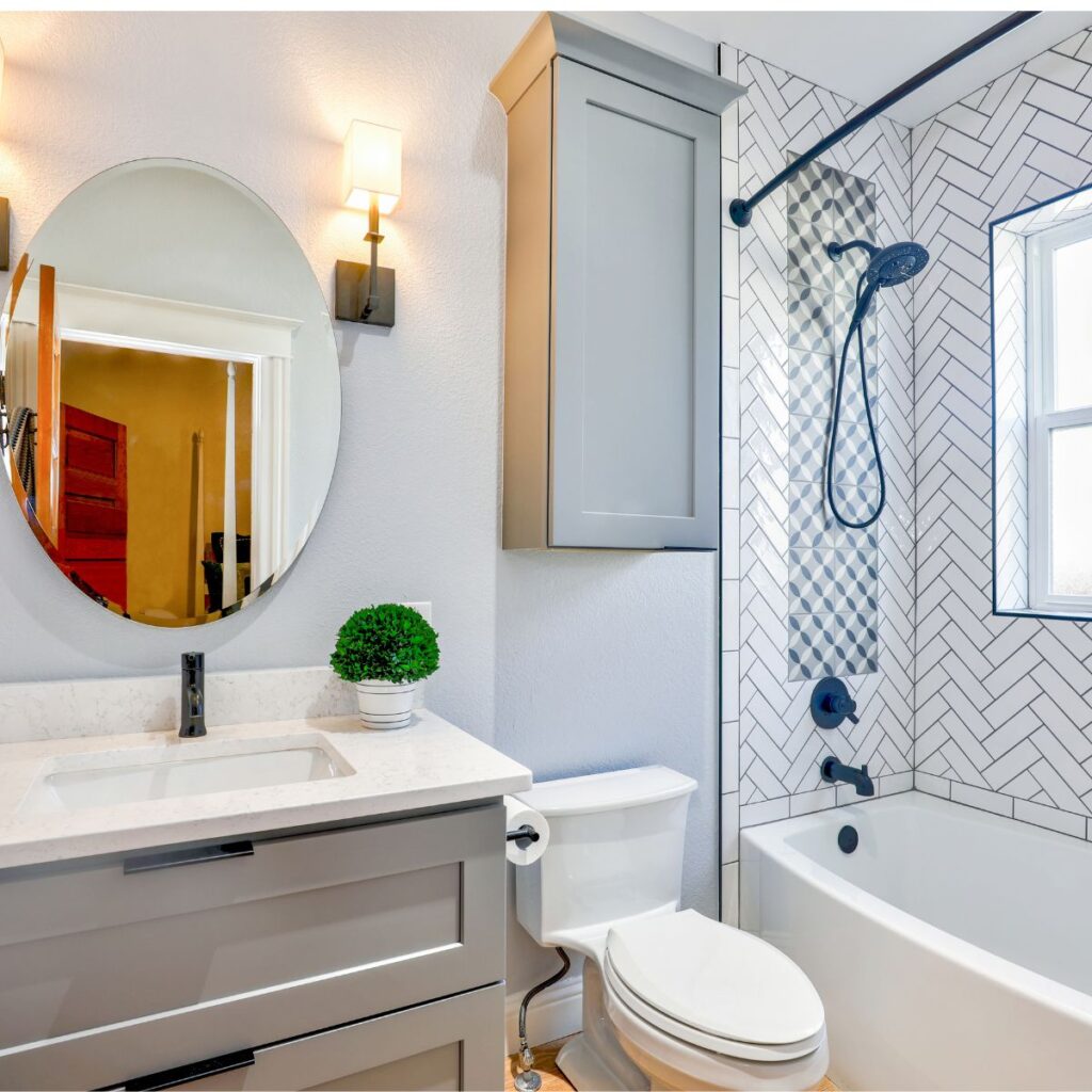 mostly white bathroom showing a mirror and a sink with some decorations filling the bathroom