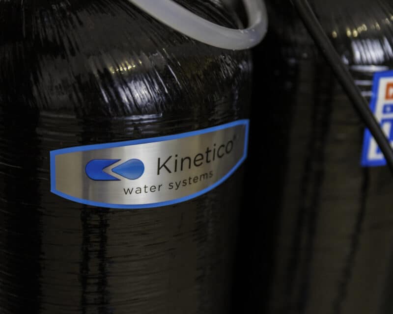 kinetico logo on a black water softener tank